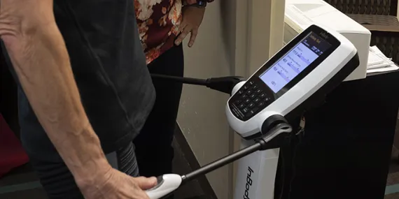 man holding onto handles of inbody machine