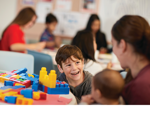 child playing with blocks on a table