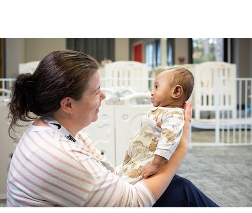 Child care staff holding infant
