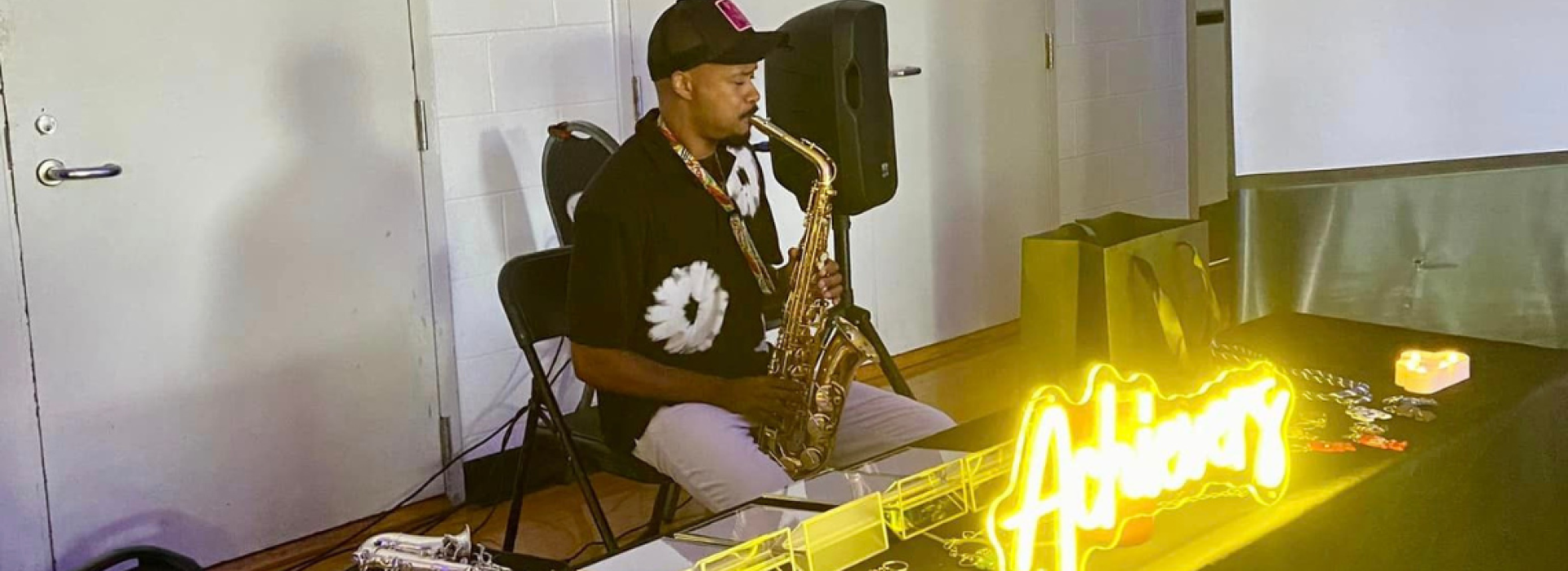 Man playing instrument at Y Achievers meeting